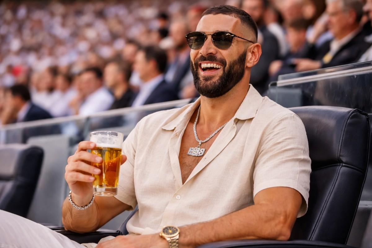 Karim Benzema enjoying a live football match from the stands, smiling and relaxing in a premium stadium setting, reflecting Karim Benzema Net Worth 2026