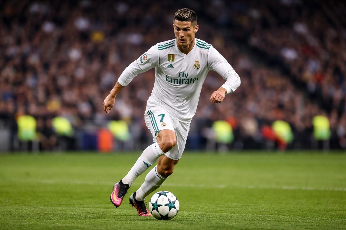 Cristiano Ronaldo playing football on the field, one of the highest paid footballers in 2026.